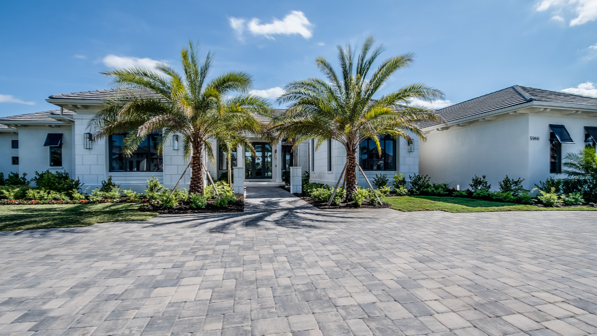 a large house with a brick driveway leading to it