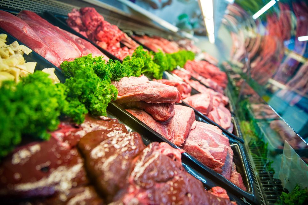 A Display Case Filled With Meat And Vegetables In A Butcher Shop — McGrath Meats In Taree, NSW