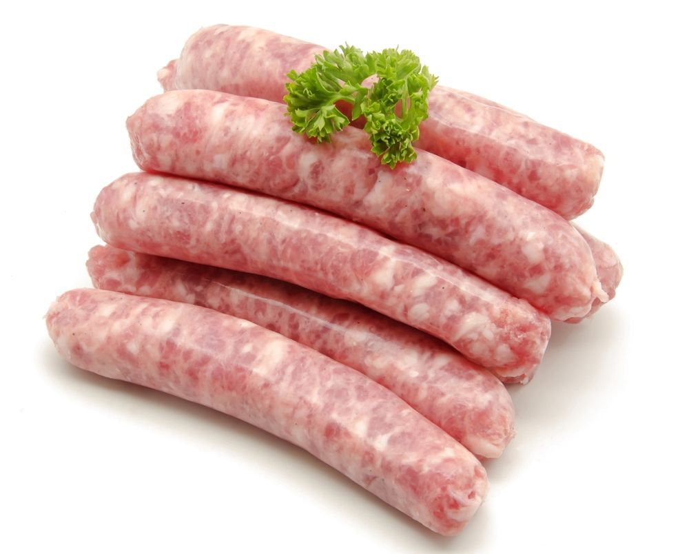 A Pile Of Raw Sausages With Parsley On A White Background — McGrath Meats In Taree, NSW