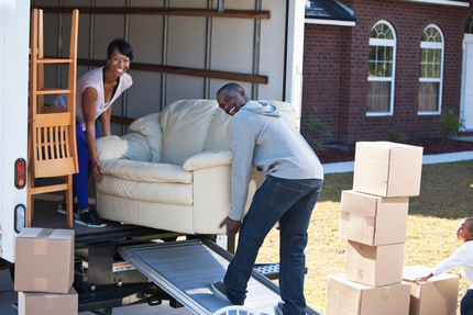 A Man and Woman Are Loading a Couch Into a Moving Truck | Tucson, AZ | Big Rick's Moving Co.