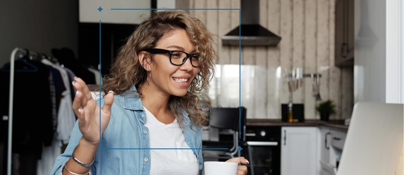 a woman wearing glasses is smiling while holding a cup of coffee