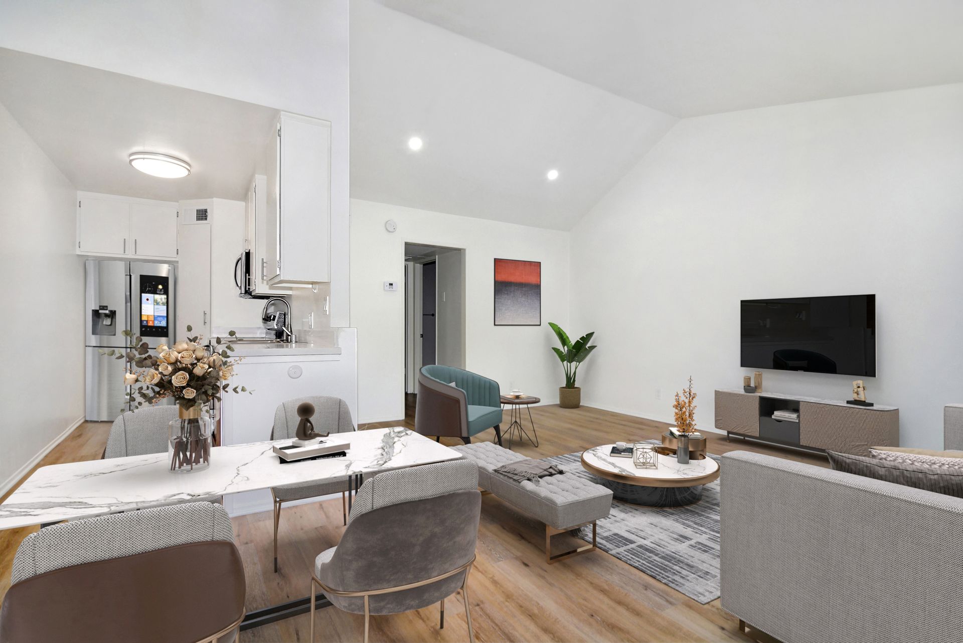 a living room with a dining table , chairs , and a flat screen tv .