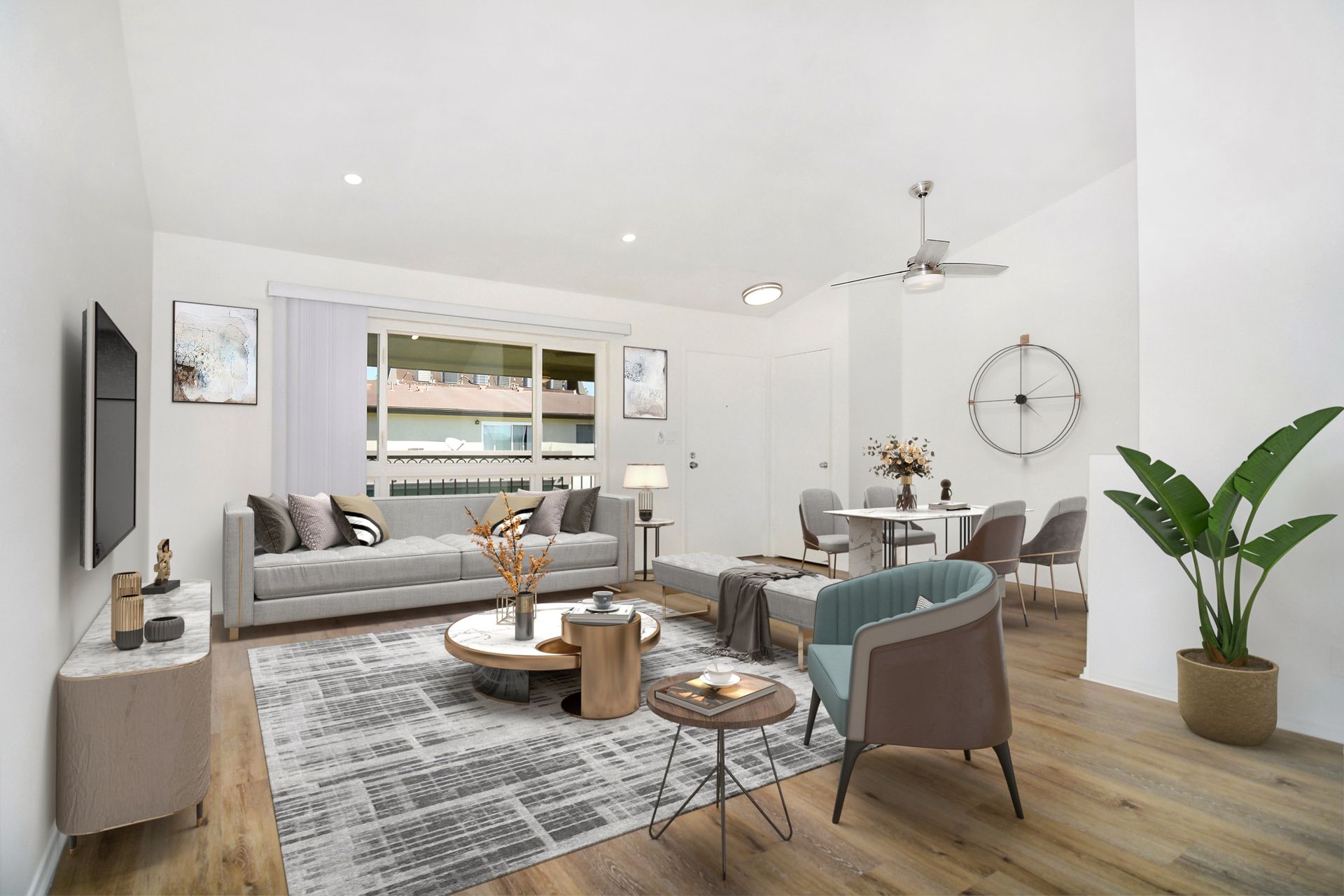 a living room with a couch , chairs , a table and a television .