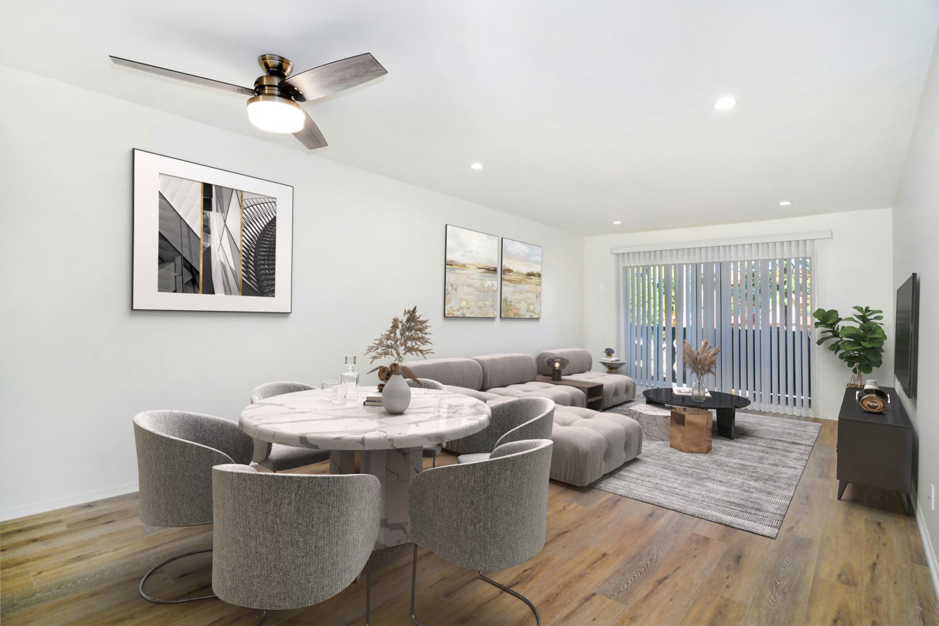 a living room with a table and chairs and a ceiling fan