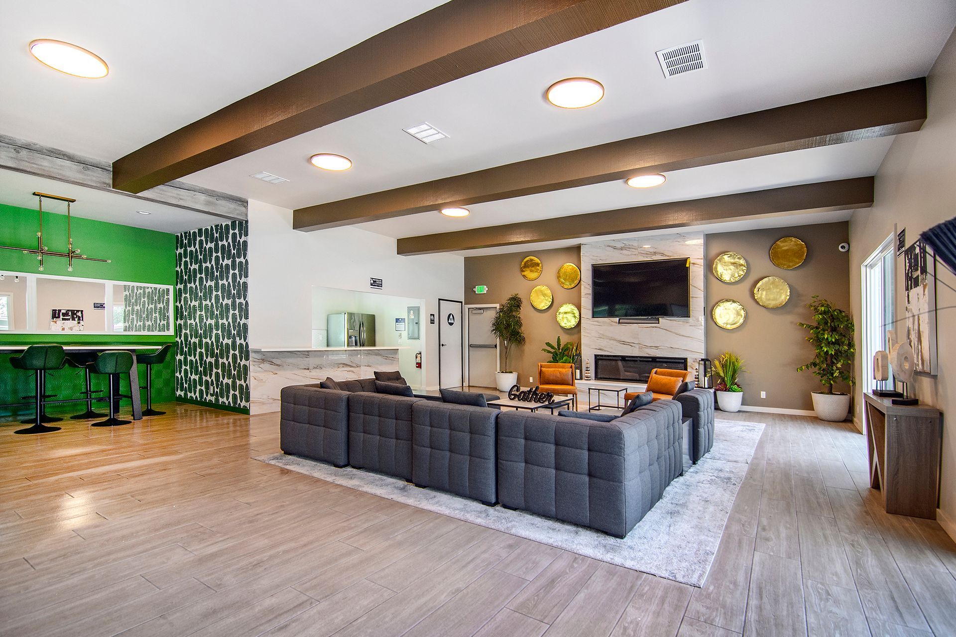 a living room with a couch , chairs , and a television .
