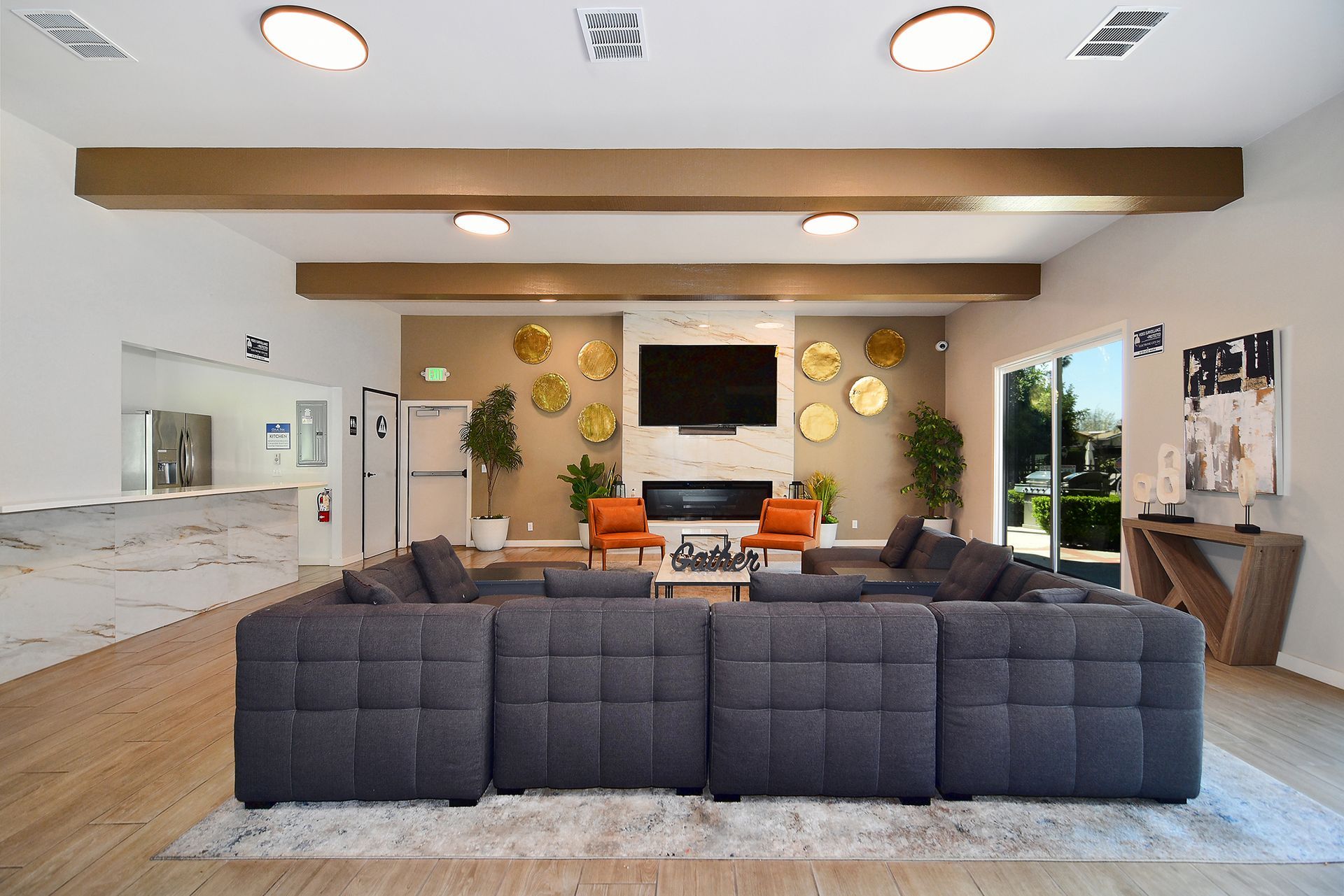 a living room with a large couch and a flat screen tv