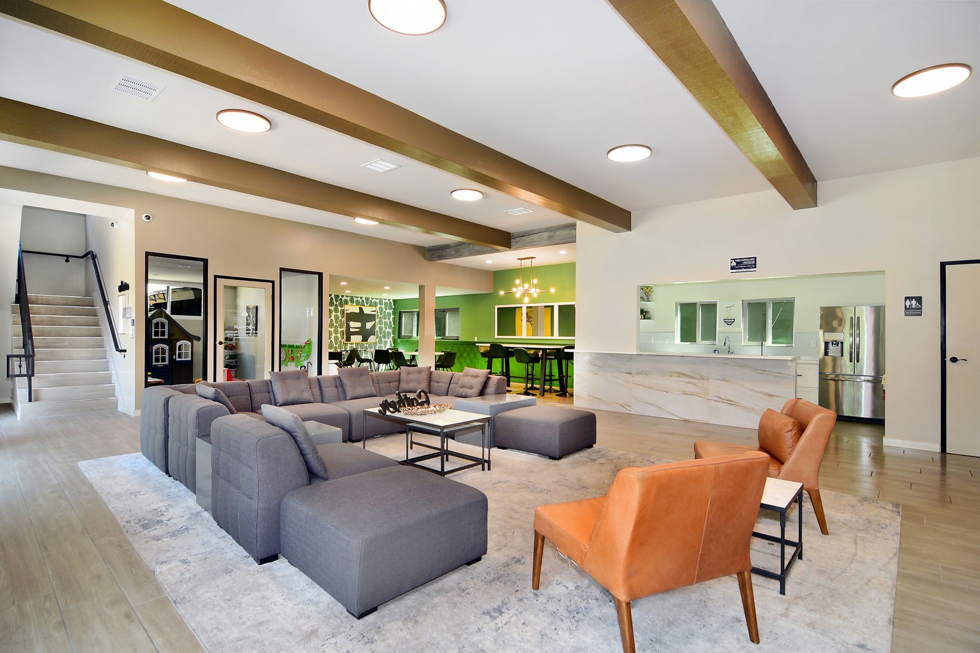 a living room with a large sectional couch and chairs