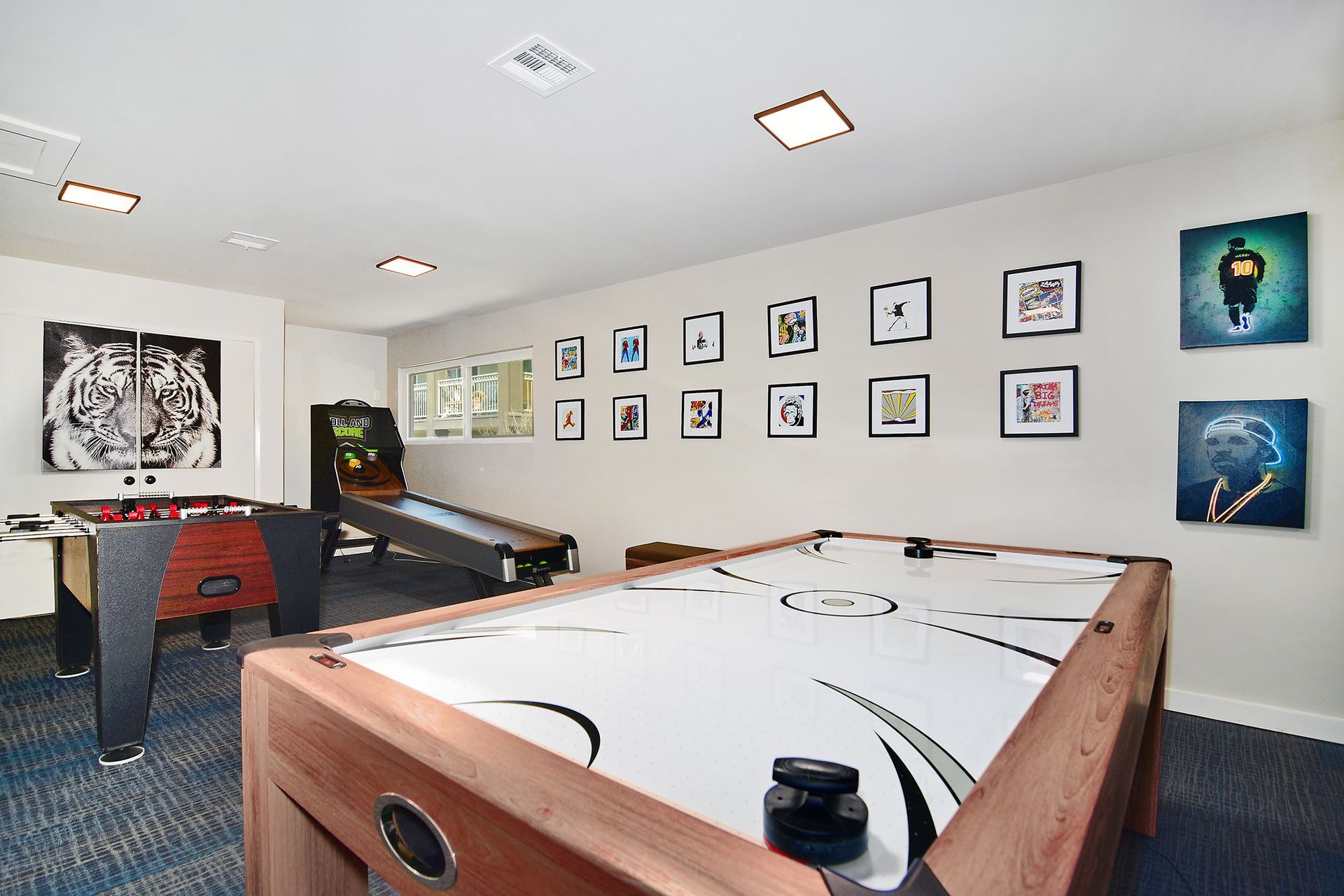 a game room with a pool table and air hockey table
