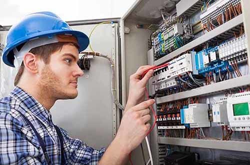 Technician Examining Fusebox With Multimeter Probe  - Myers G W Electrical Contractors Inc in Kill Devil Hills, NC