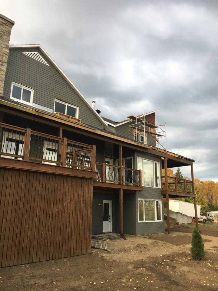 Une grande maison avec beaucoup de fenêtres et une grande terrasse