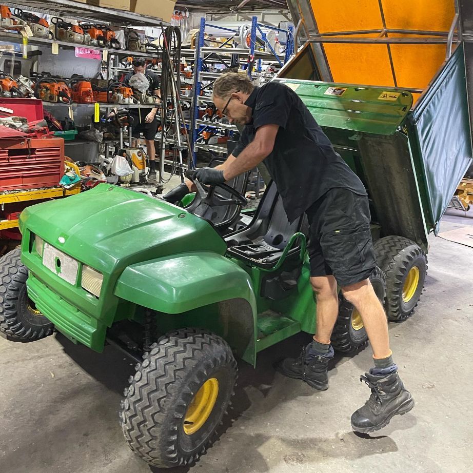 Man Repairing John Deere Mower — Farm Equipment Experts In Byron Bay, NSW