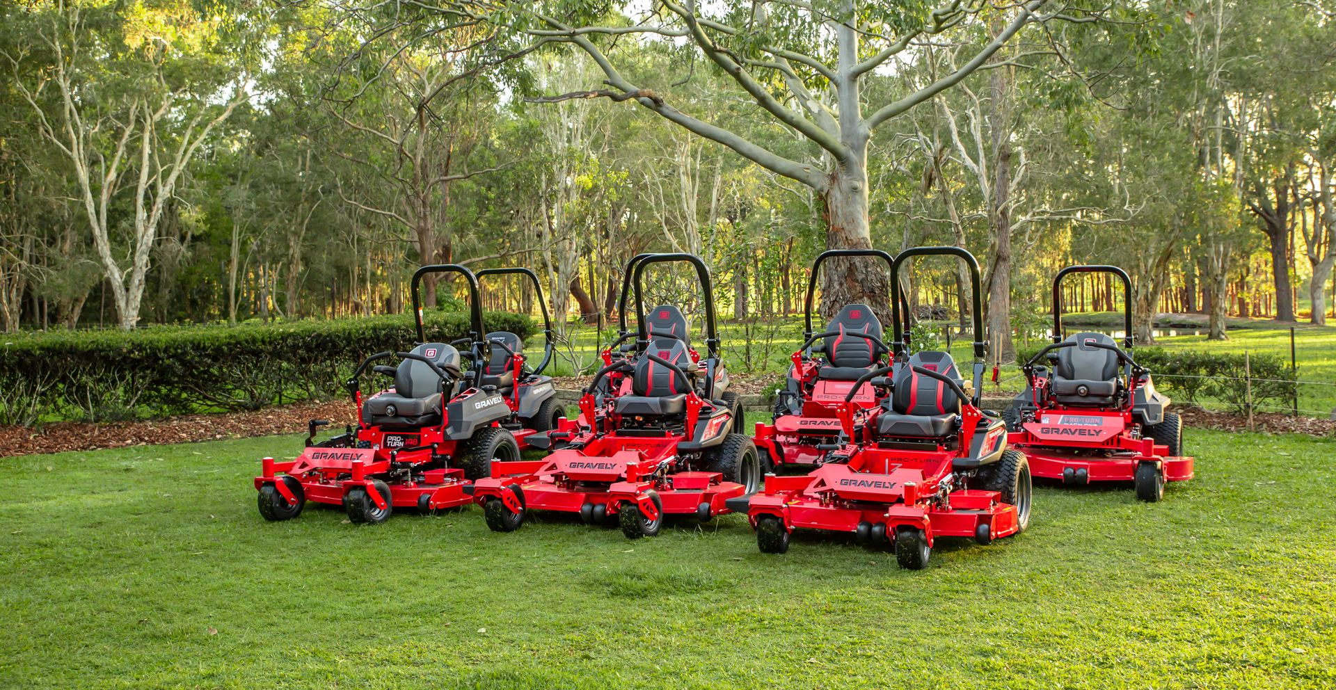 line up of red gravely ride on mower range