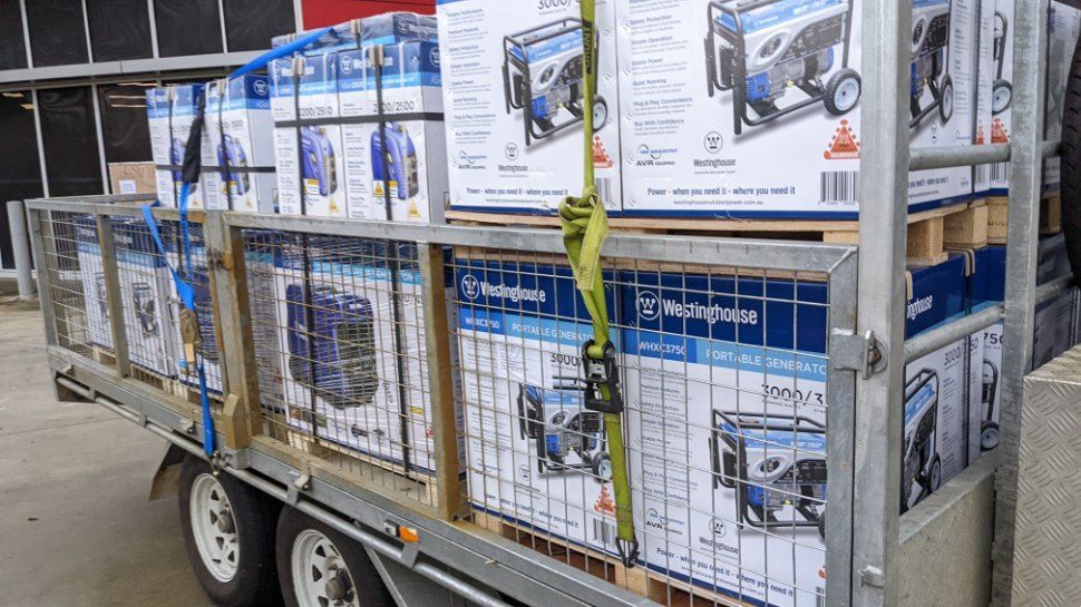 A Trailer is Loaded With Boxes of Generators — FarmCare in Mullumbimby, NSW