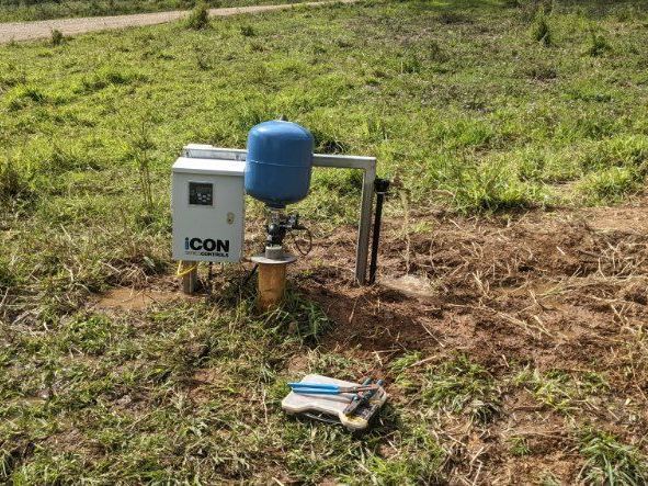 A Water Pump is Sitting in the Middle of a Grassy Field — FarmCare in Mullumbimby, NSW
