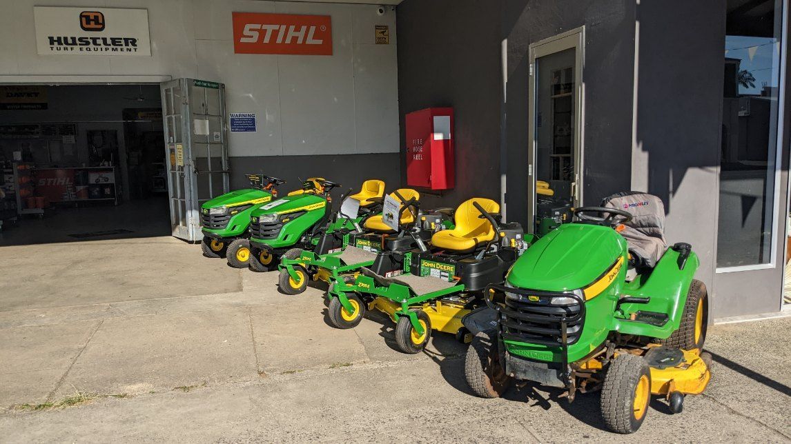 John Deere Lawn Mowers Are Parked in Front of a Building — FarmCare in Mullumbimby, NSW