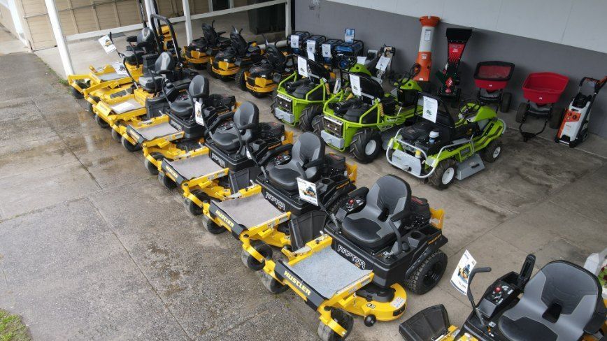 A Row of Lawn Mowers Are Lined Up in a Parking Lot — FarmCare in Mullumbimby, NSW