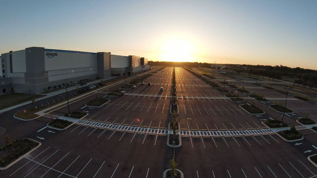 An aerial view of an empty parking lot at sunset