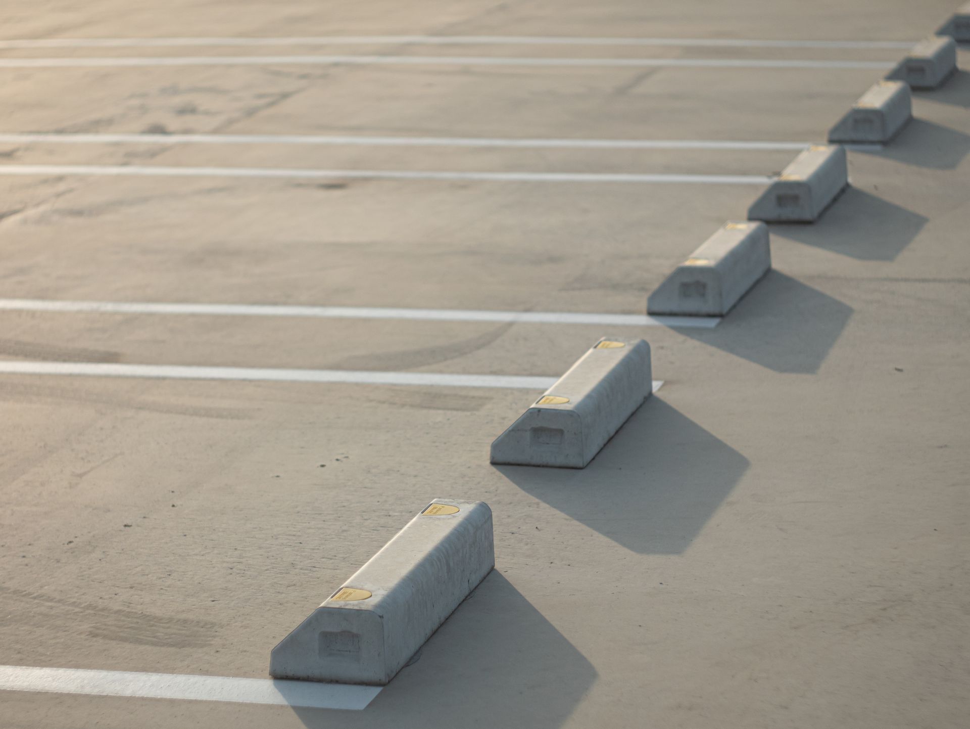A row of parking blocks in a parking lot