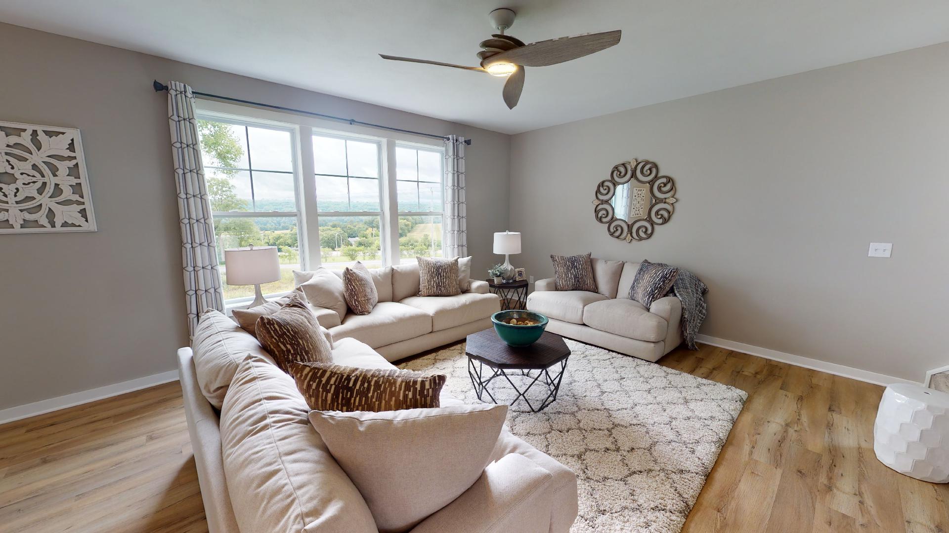 2 couches, loveseat, and ceiling fan in living room