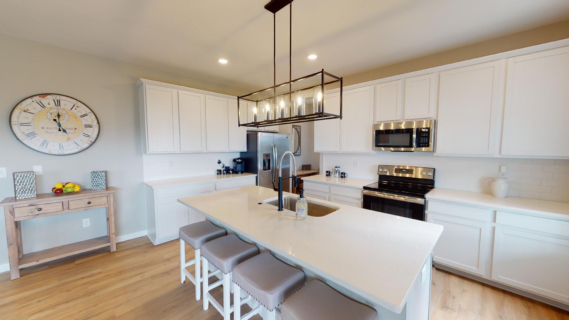 white kitchen with stainless steel appliances