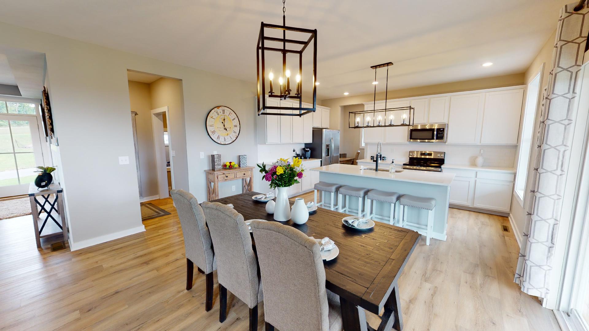 open dining room and kitchen with rectangular lighting
