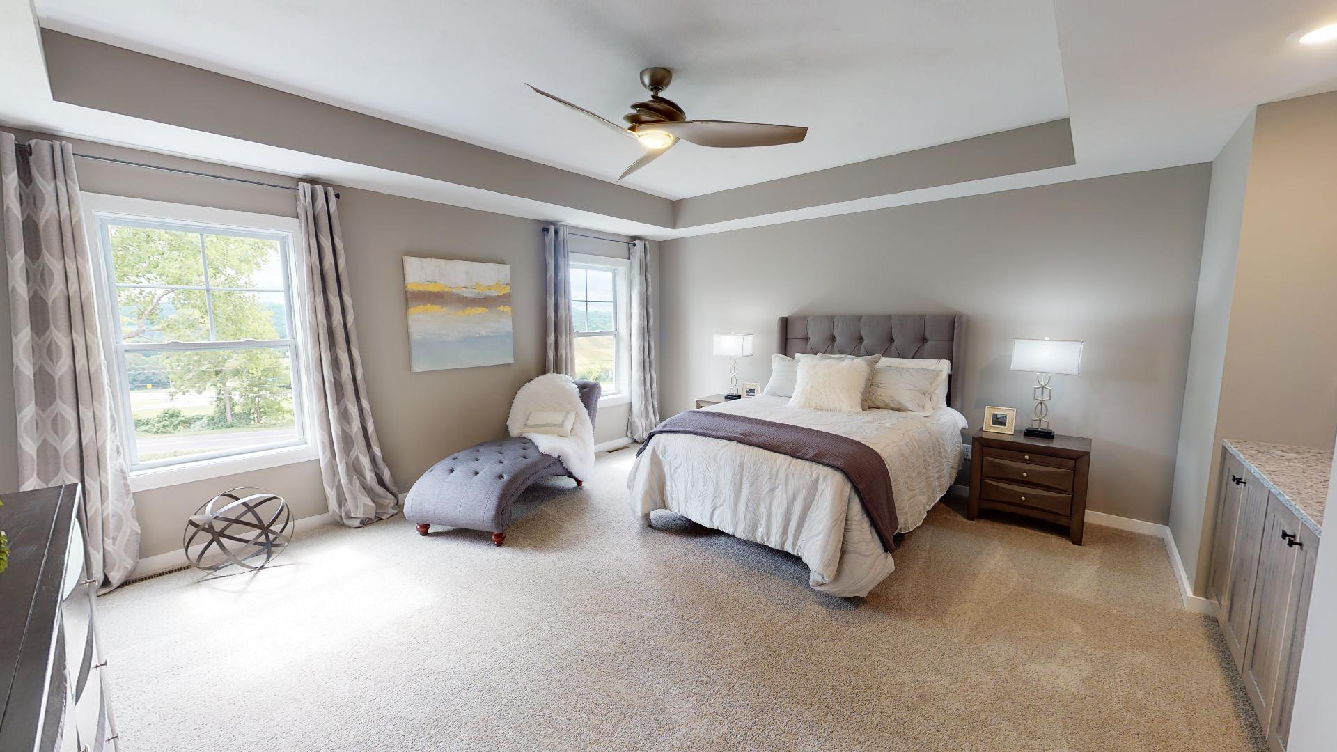 primary bedroom with recessed ceilings