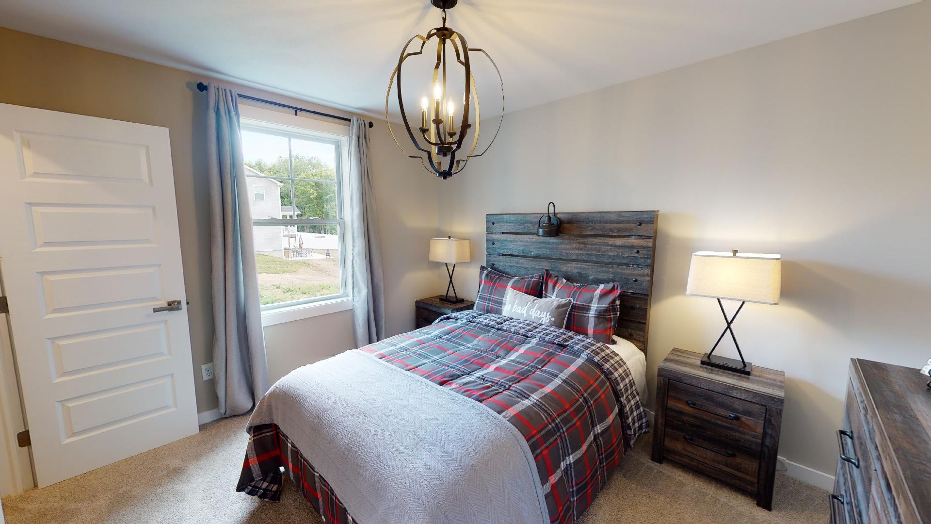 bedroom with rustic metal light fixture