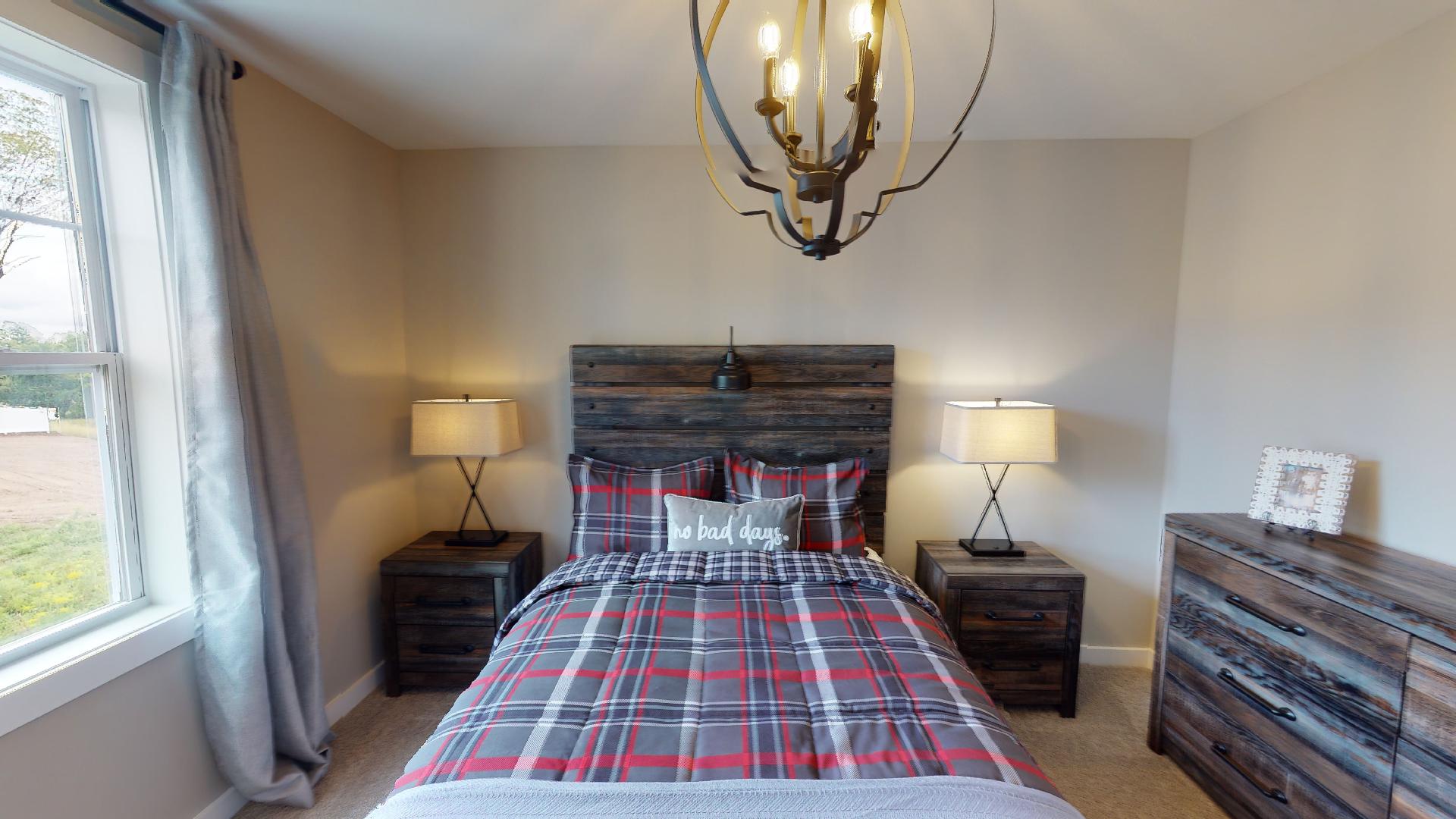bedroom with rustic metal light fixture