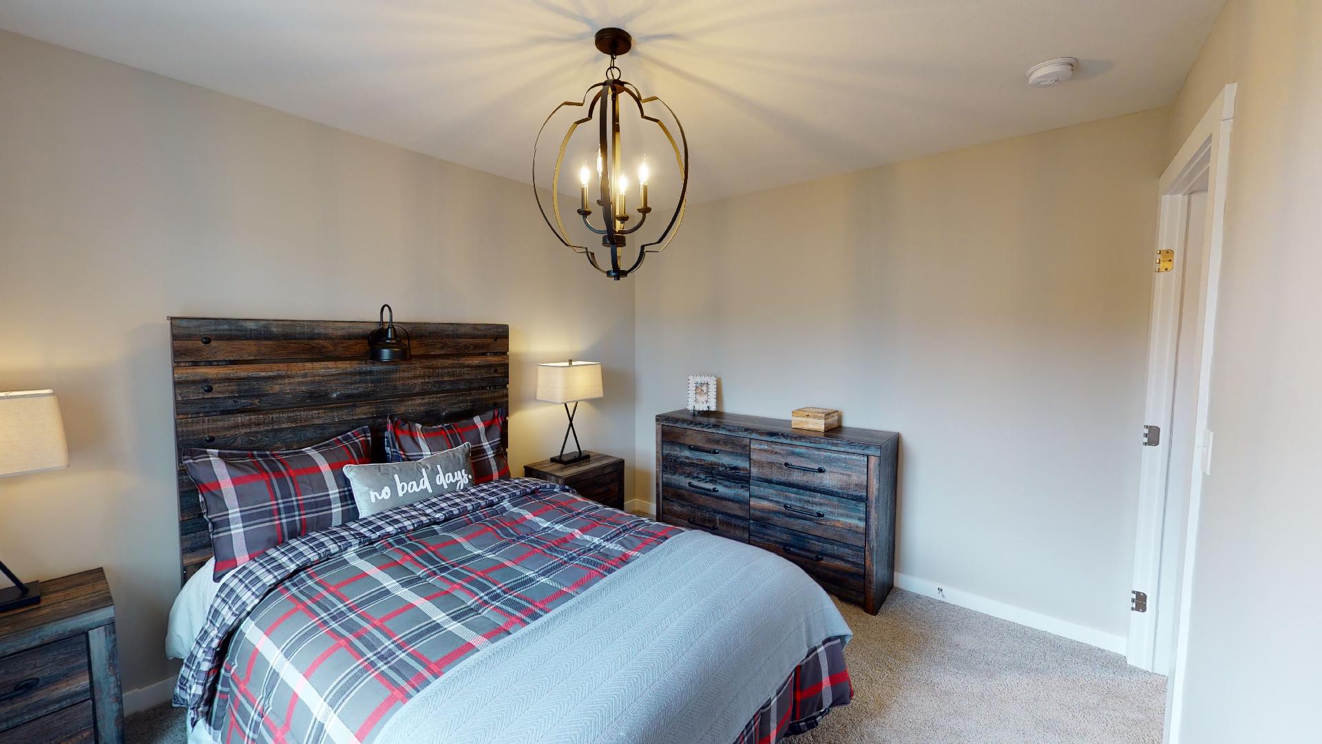 bedroom with rustic metal light fixture