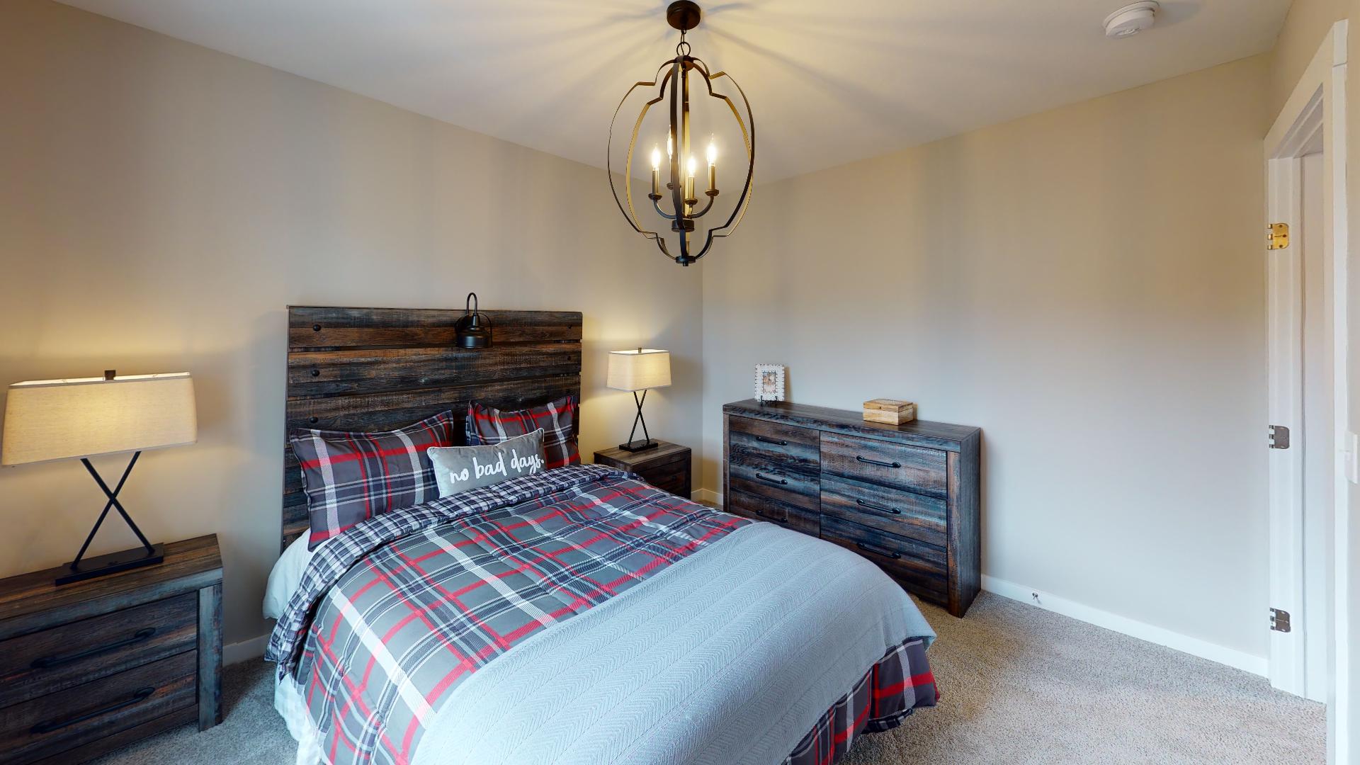bedroom with rustic metal light fixture