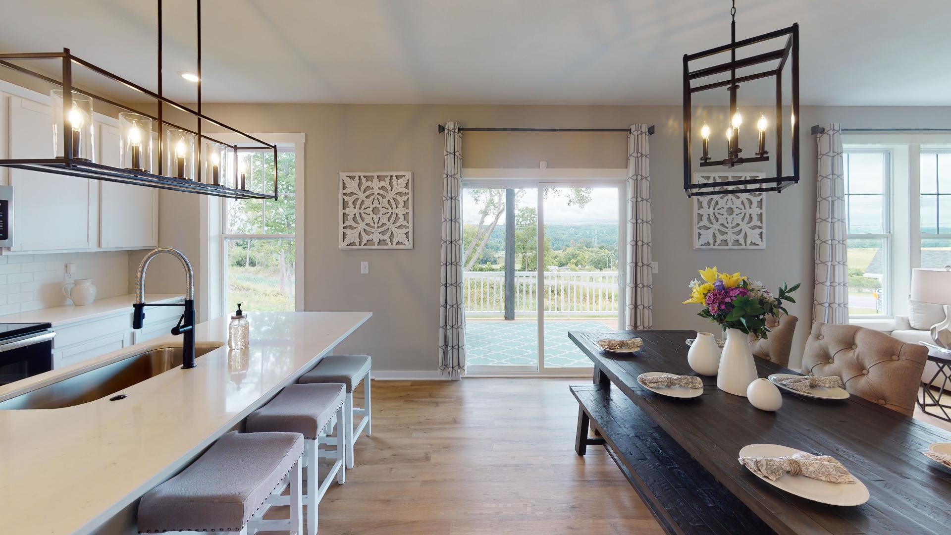 open kitchen and dining room with rectangular lighting