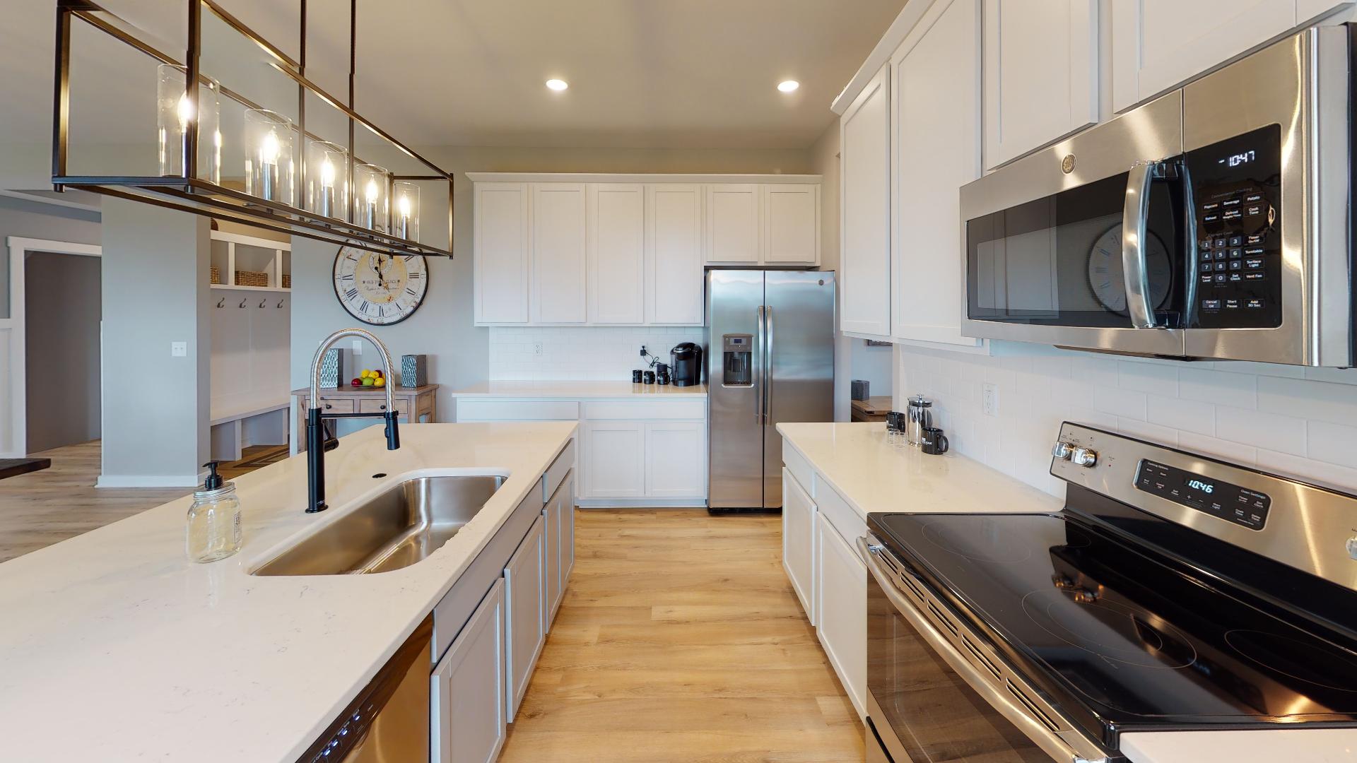 white kitchen with stainless steel appliances