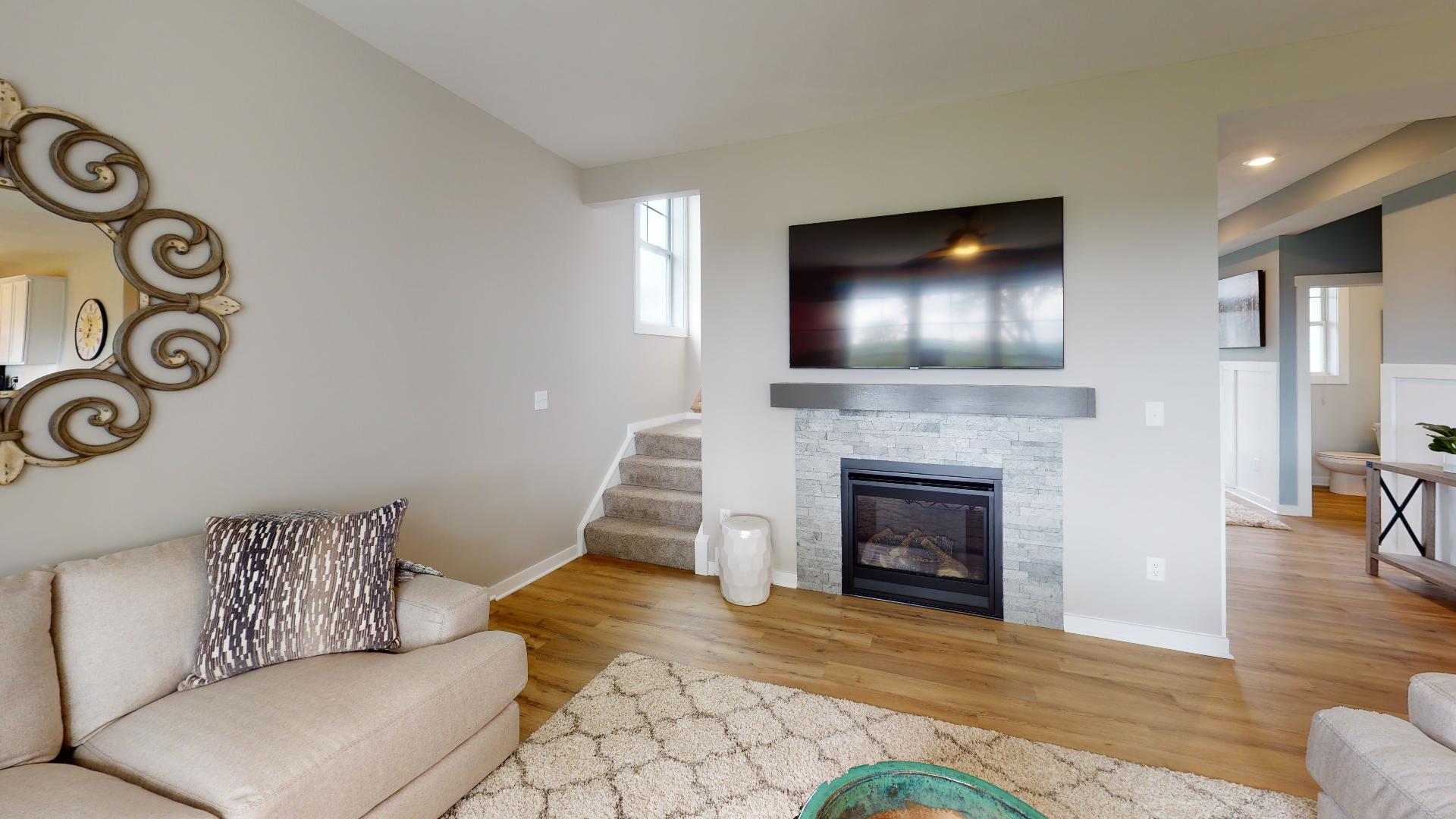 stairs and living room with fireplace