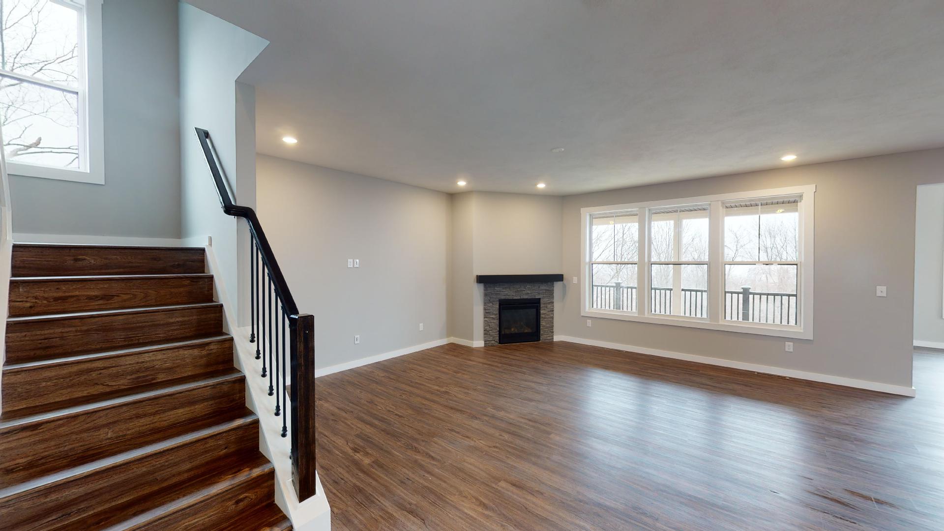 stairs and living room with fireplace