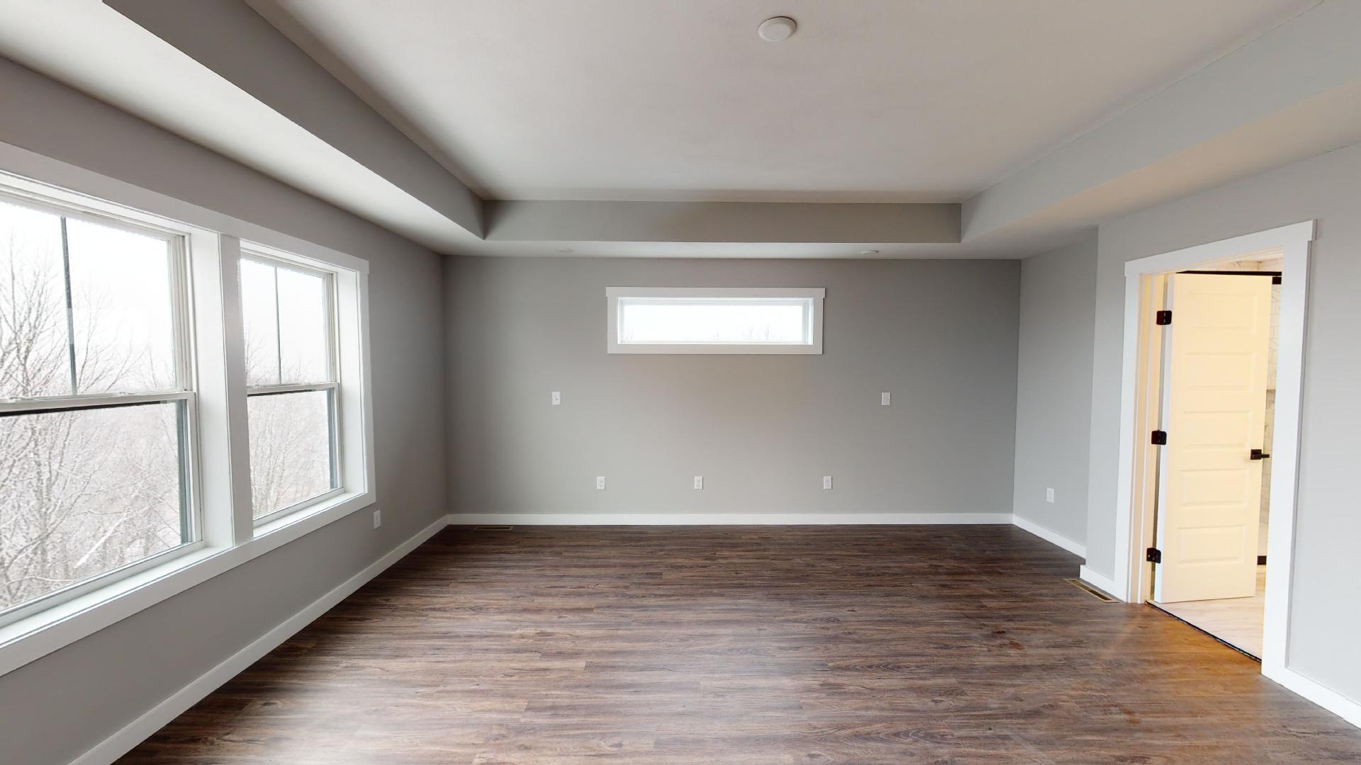primary bedroom with recessed ceilings