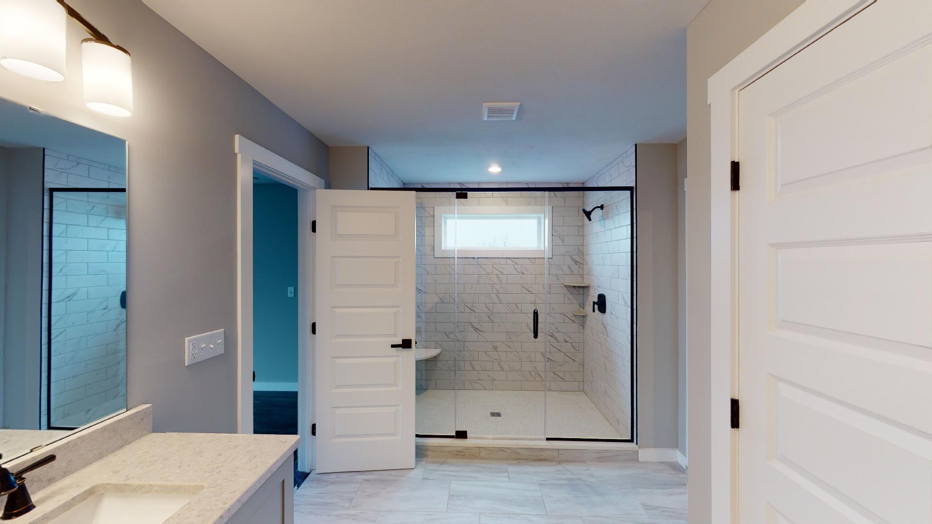 primary bedroom shower with built-in bench