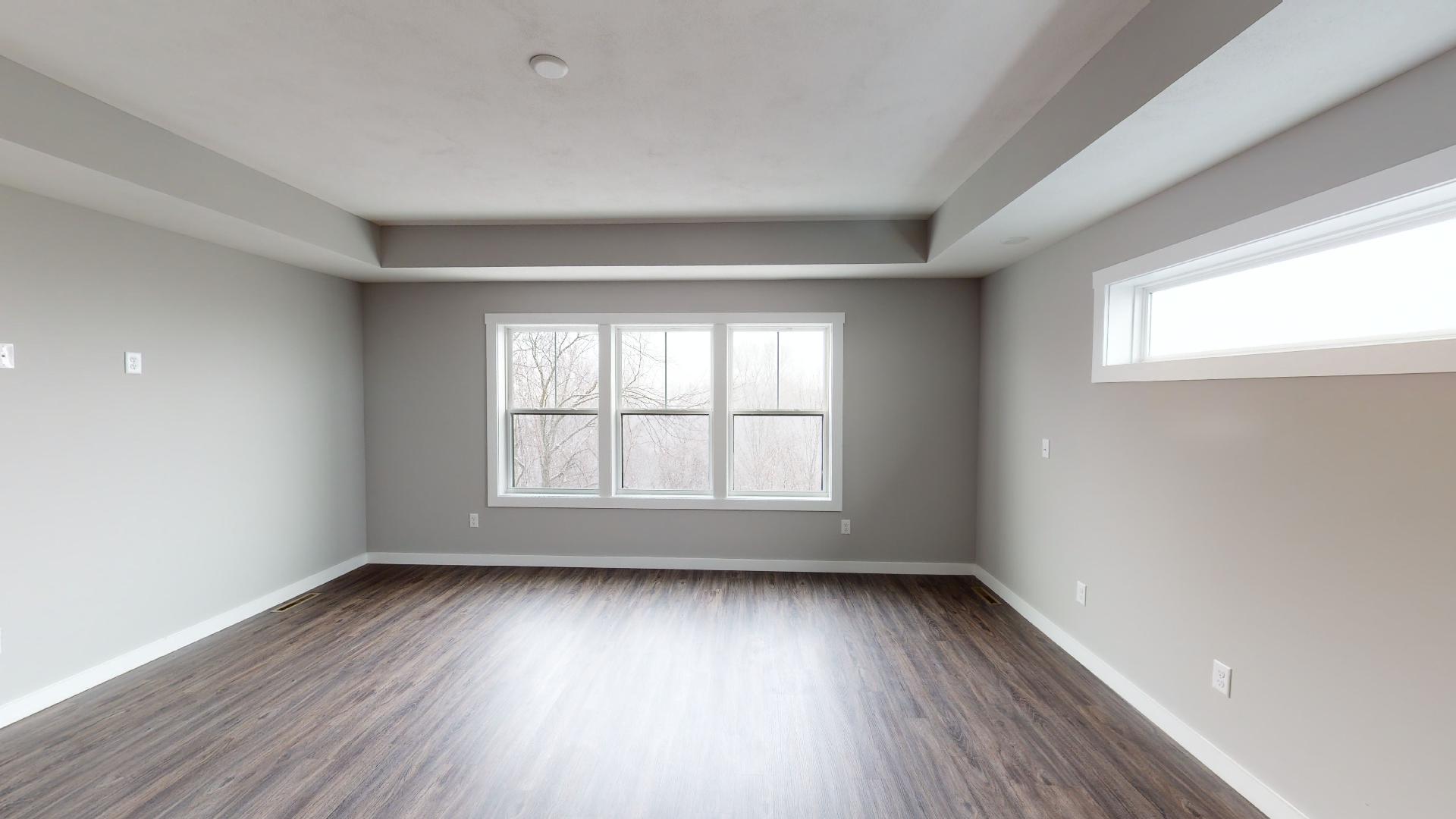 primary bedroom with recessed ceilings