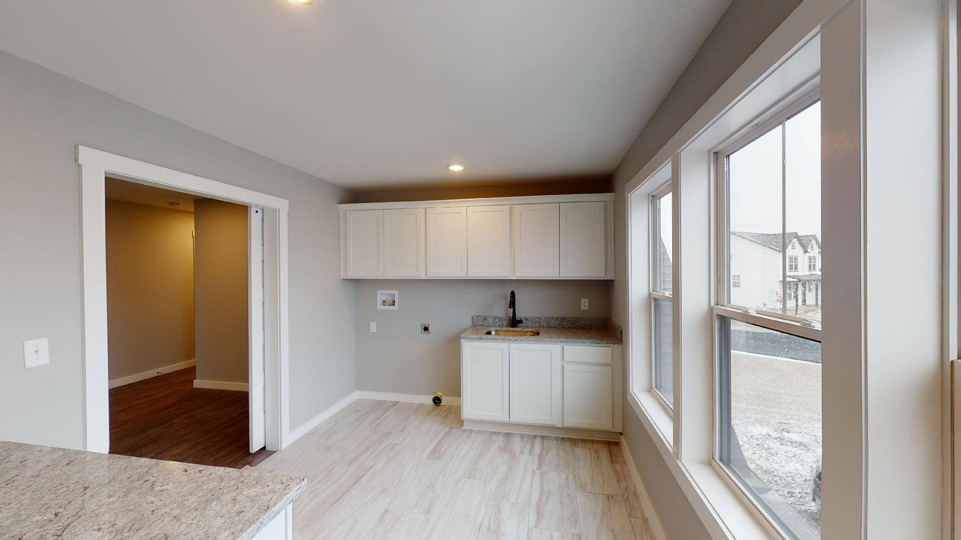 laundry room with cabinets and sink