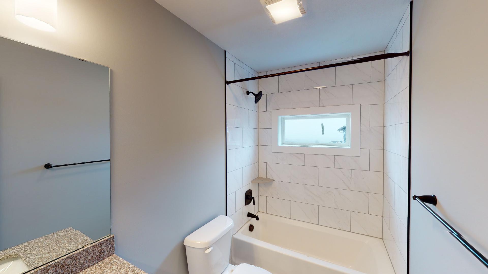 bathroom with tile tub and shower combo