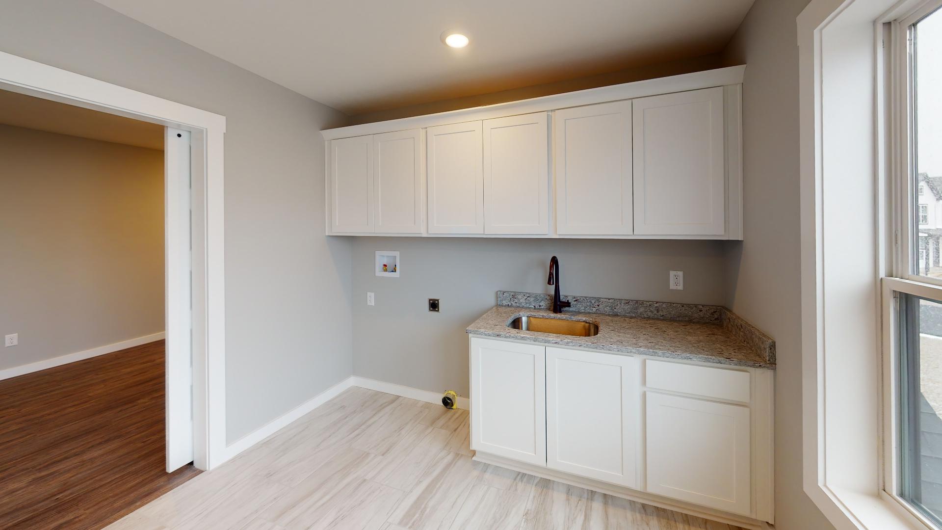 laundry room with cabinets and sink