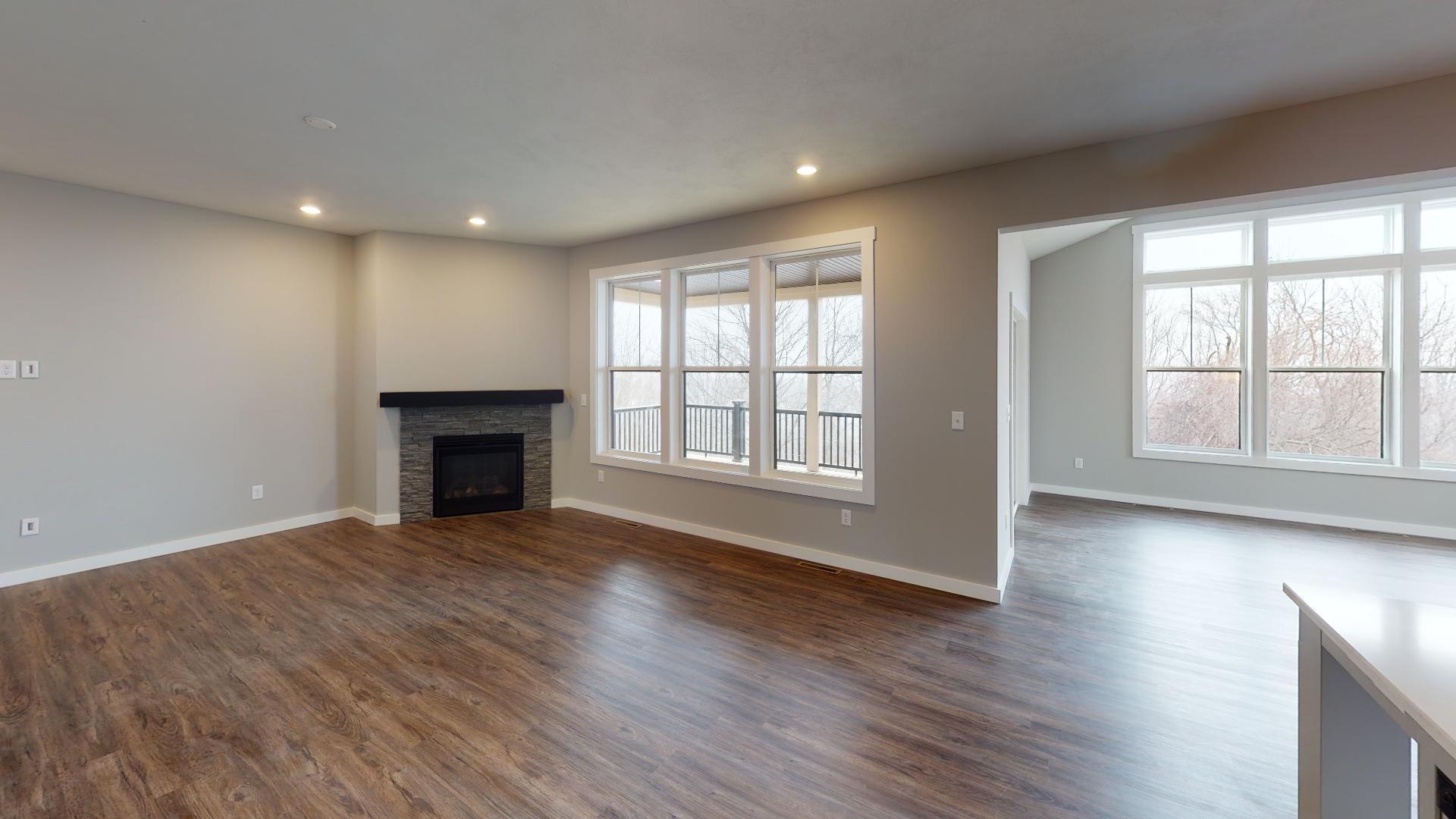 living room with fireplace and dining room in background