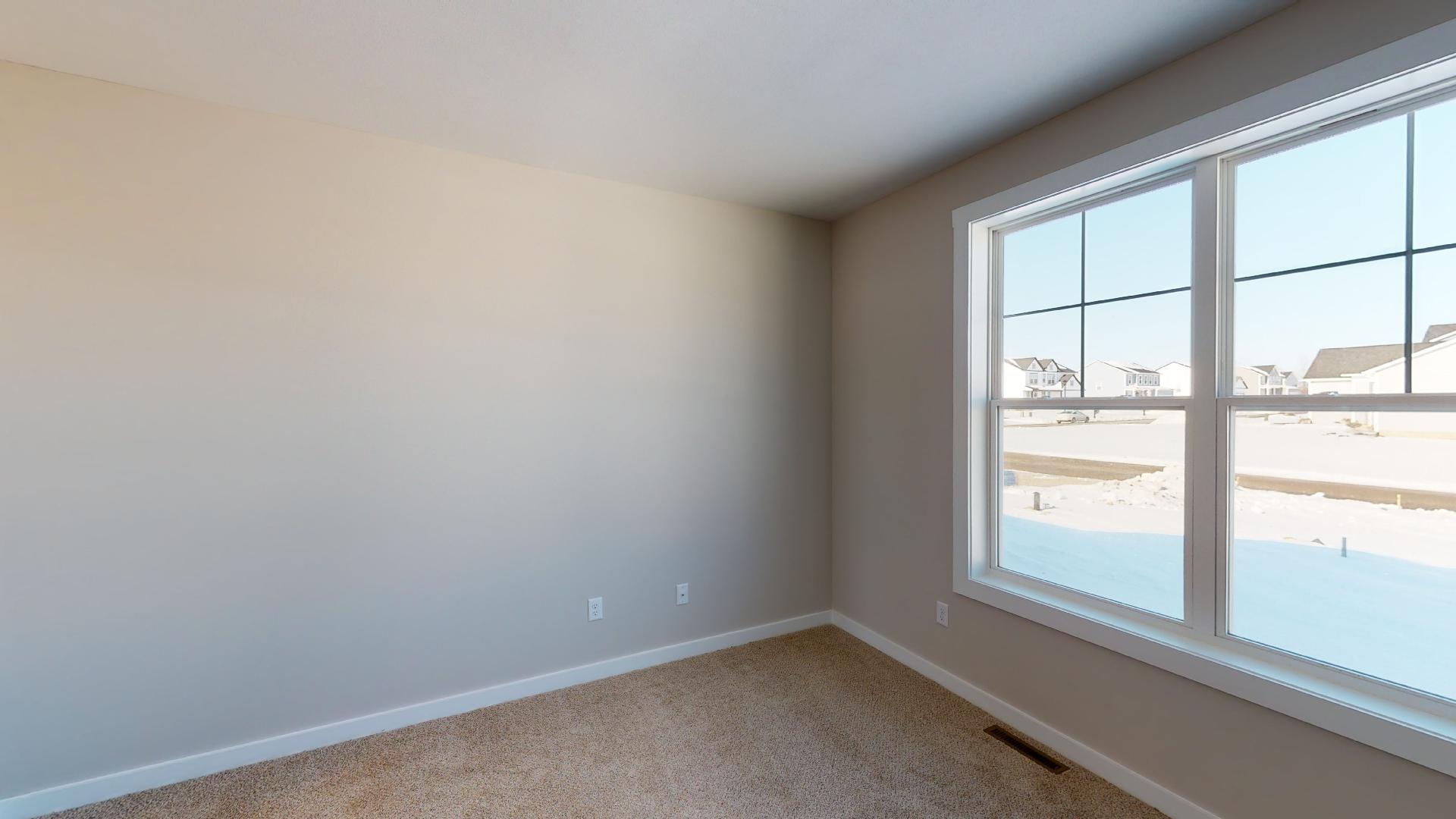 bedroom with windows facing street