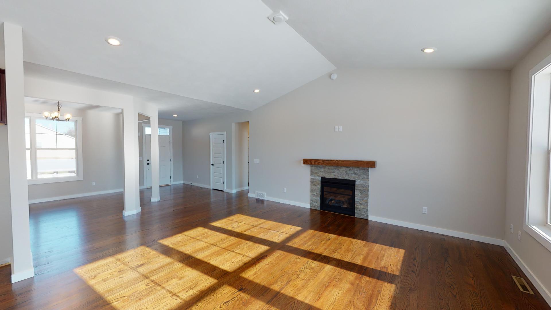 living room with fireplace and vaulted ceiling
