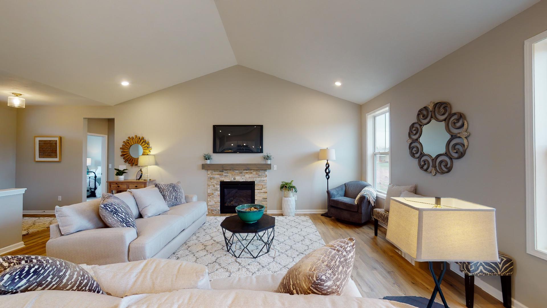 living room with fireplace and vaulted ceiling