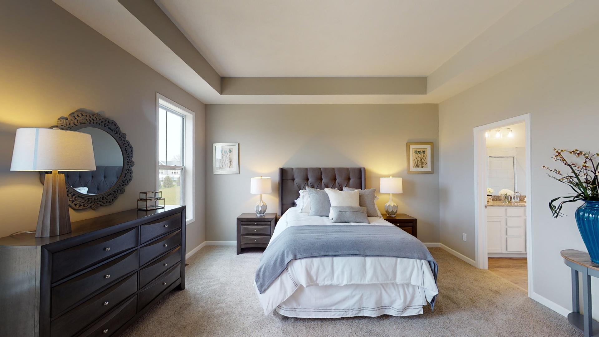 primary bedroom with recessed ceilings