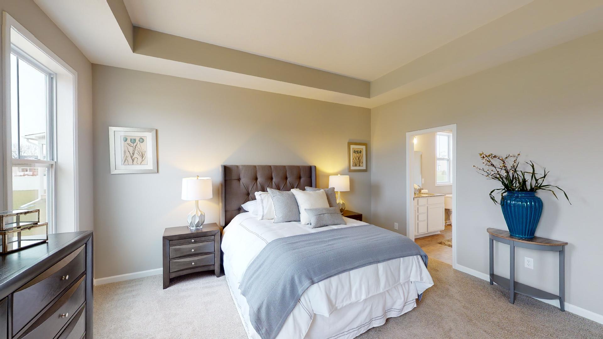 primary bedroom with recessed ceilings