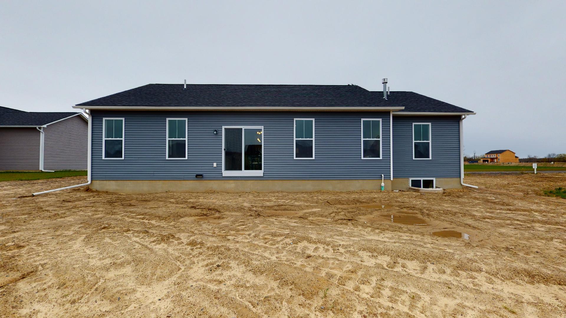 back exterior and backyard of home