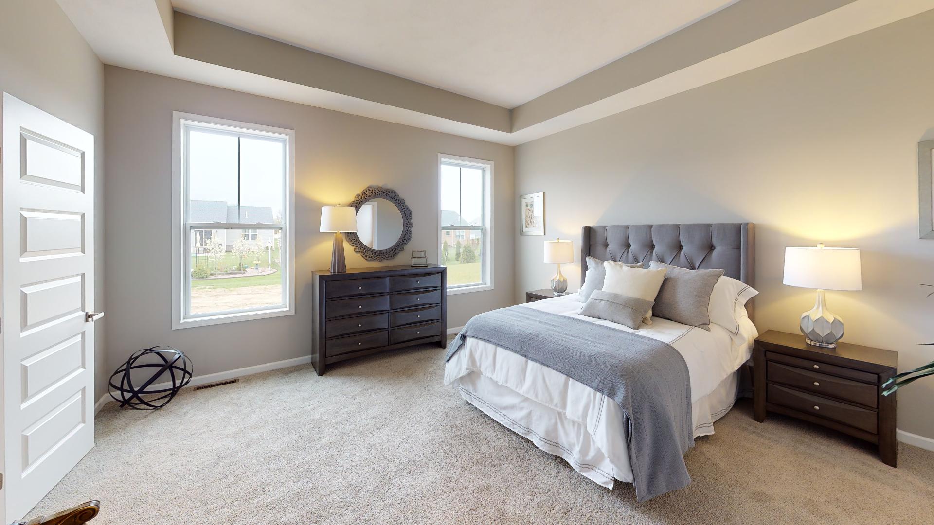 primary bedroom with recessed ceiling