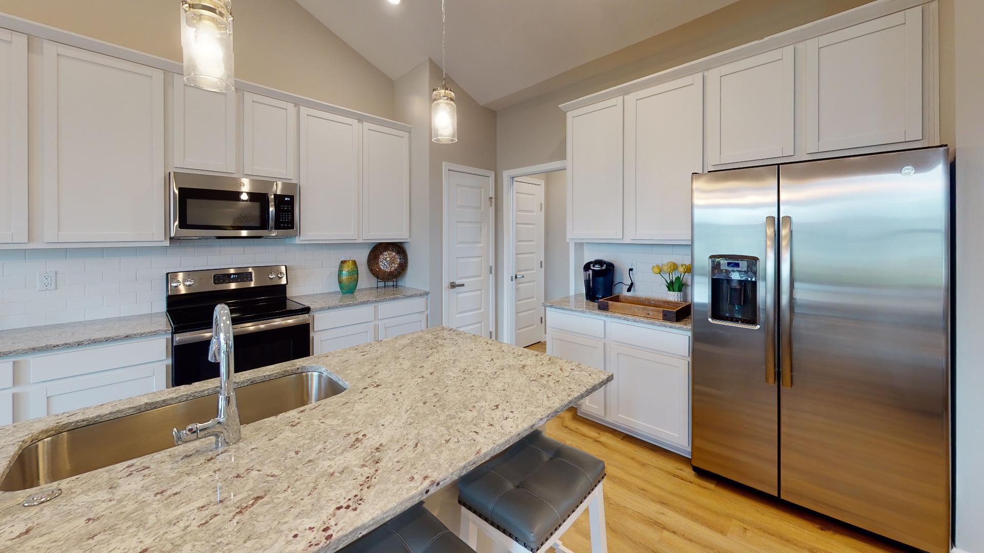 kitchen with stainless steel appliances and island with sink