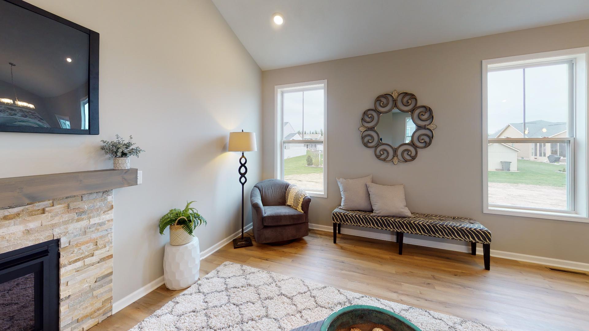 living room with fireplace and windows facing backyard